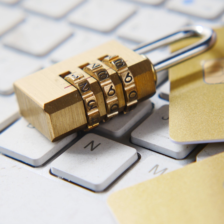 Gold Lock on top of White Keyboard